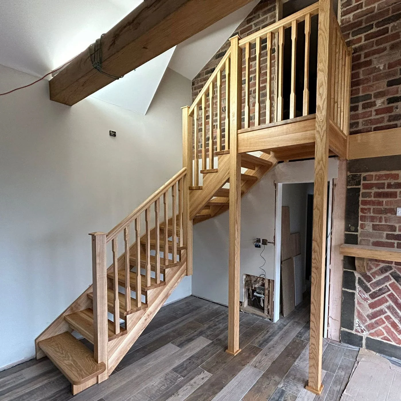 Handcrafted timber staircase with matching balustrades and an open, light-filled landing